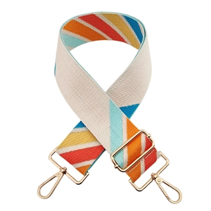 Detail of colorful geometric jacquard pattern webbing strap with golden metal buckles