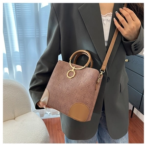 Fashionable women's bucket bag with vintage monogram print and metal ring handle details