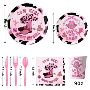 Pink Cowgirl themed party tableware set with plates cups napkins and cattle print decor