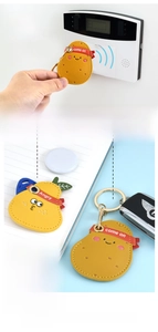 Close-up of potato and pear leather cases with metal keyrings for access cards