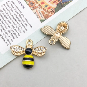 Macro view showing both sides of a yellow honey bee pendant with rhinestones and enamel