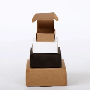 Stacked kraft and cardboard jewelry gift boxes in various sizes and colors on white background