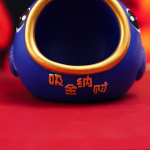Detail of blue koi fish tray with gold characters meaning wealth and fortune