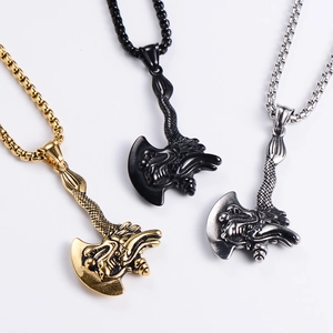 Detail of dragon-engraved axe pendants in gold, black, and silver stainless steel