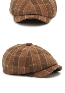Close-up of deep brown plaid newsboy cap showing wool blend texture and button detail
