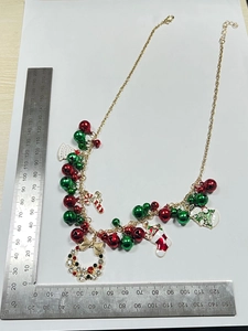 Christmas necklace size measurement with Santa, bell, and snowman enamel charms on gold chain