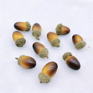 Macro shot of artificial brown acorns with realistic textured caps on white fur background