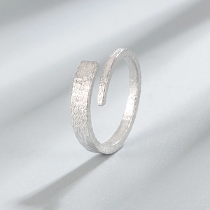 Minimalist 925 sterling silver open ring with unique frosted bark texture on grey background