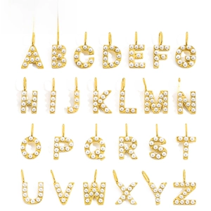 Complete set of 26 gold stainless steel alphabet pendants with pearl inlay details