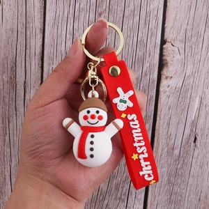 Detailed close-up of a Christmas snowman keychain with a red silicone strap and gold ring
