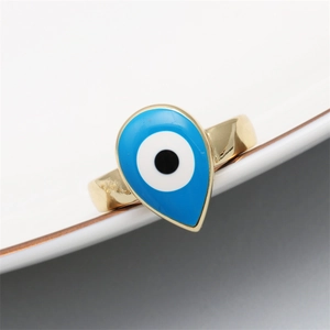 Detailed view of teardrop evil eye ring with blue enamel on gold plated band