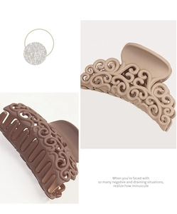 Detail of matte hollow scroll hair claw clips in beige and dark coffee brown colors