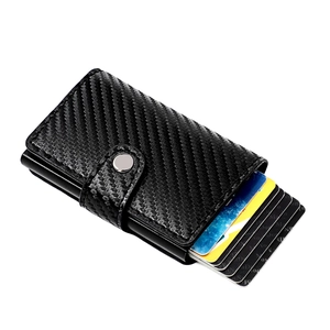 Close-up of slim carbon fiber RFID wallet with automatic pop-up cards and silver buckle