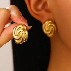 Macro shot of 18K gold plated spiral earring with polished 3D textured surface