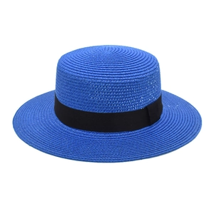 Detail of royal blue boater hat with black grosgrain ribbon and straw woven texture