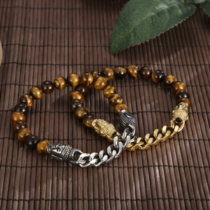 Close-up of tiger eye bead bracelet with Buddha head pendant and Cuban link chain