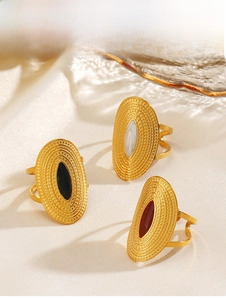 Detailed shot of gold-plated oval rings featuring black, white and red enamel inlays