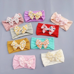 Nylon floral bow headbands for babies in nine assorted colors and patterns
