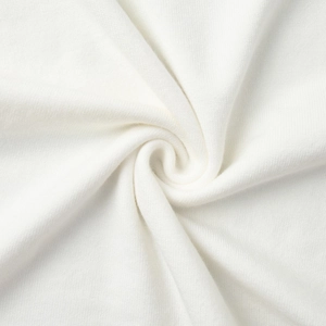 Close-up of soft white knitted fabric texture for women's cardigan and dress set