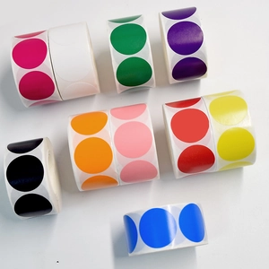 Macro shot of colorful round paper label rolls in various bright vibrant matte shades