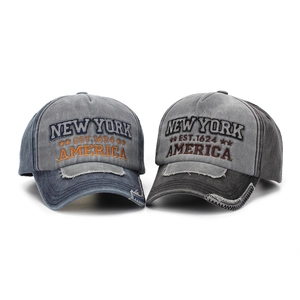 Detailed view of vintage washed canvas baseball caps with 3D New York embroidery and distressed brim