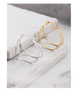 Macro detail of gold and silver S925 sterling silver minimalist double line hoop earrings
