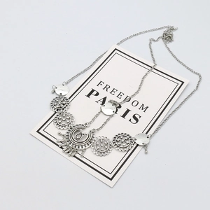 Detail of silver bohemian headpiece with crescent moon pendant on white background