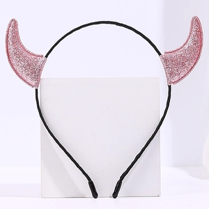 Close-up view of glittery pink devil horn headband for Halloween parties and festivals.