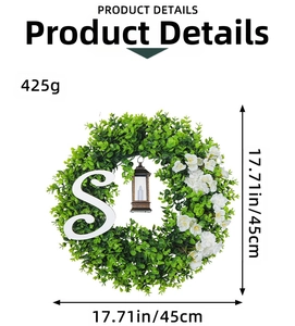 Christmas wreath with eucalyptus leaves, vintage black lantern, and letter S on white background
