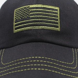 Detailed embroidery of the American flag on a black cotton tactical baseball cap