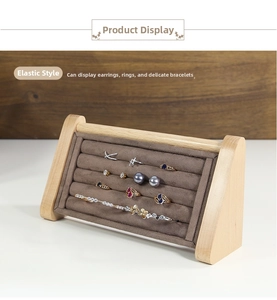Detail view of wooden jewelry display stand with brown velvet slots for rings and earrings