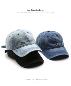 Detailed close-up of retro washed denim baseball caps with Pamela Raina embroidery