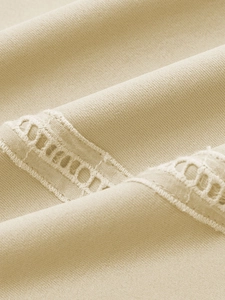 Macro shot of apricot striped polo fabric texture with detailed hollow lace pattern