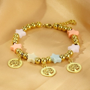 Close-up of golden beaded bracelet with colorful star beads and tree of life pendants