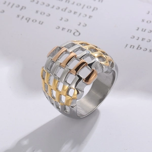 Close-up of tricolor woven mesh stainless steel ring with polished gold and silver bands
