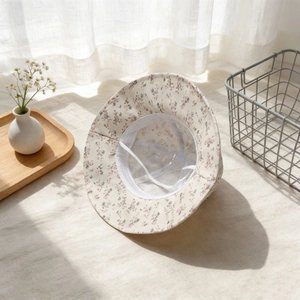 Détail chapeau de soleil bébé à fleurs avec doublure en mesh et attaches réglables