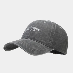Detail of white Hello Gorgeous embroidery on charcoal washed cotton baseball cap