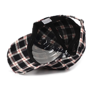 Detail of plaid baseball cap with adjustable metal buckle and internal fabric label