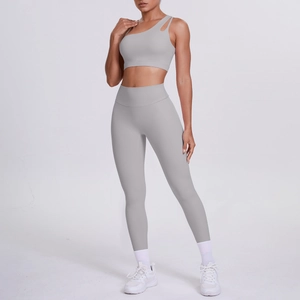 Close-up of light gray one-shoulder sports bra and high-waisted seamless yoga leggings set