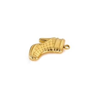 Detailed view of a golden stainless steel boot pendant with textured lattice finish