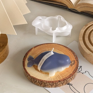 DIY whale shaped scented candle with semi-transparent silicone mold on a wooden base