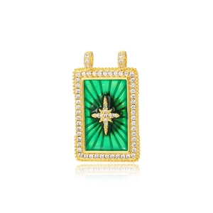 Macro shot of gold rectangle pendant with green gem and star detail for DIY jewelry