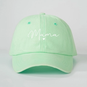 Macro detail of embroidered white Mama script and heart on mint green cotton baseball cap