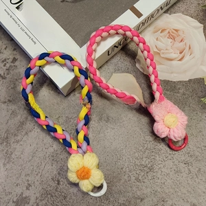 Macro detail of hand-woven floral phone lanyards with colorful crochet flowers and rings
