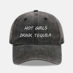 Close-up of vintage washed grey baseball cap with white HOT GIRLS DRINK TEQUILA embroidery