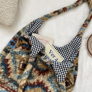 Close-up of retro plaid plush tote bag with thick knit texture and inner gingham lining