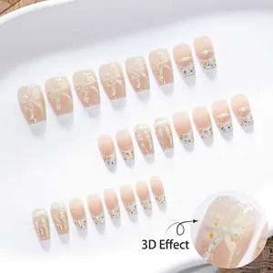 3D bow cat-eye press-on nails with floral patterns and pearl accents on white tray