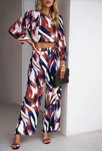 Detailed close-up of abstract red blue and white printed long sleeve crop top and pants