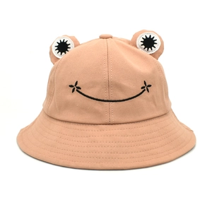 Detailed close-up of pink frog bucket hat with 3D eyes and smile embroidery