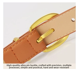 Detail of a brown leather belt with a polished gold alloy needle buckle and fine stitching